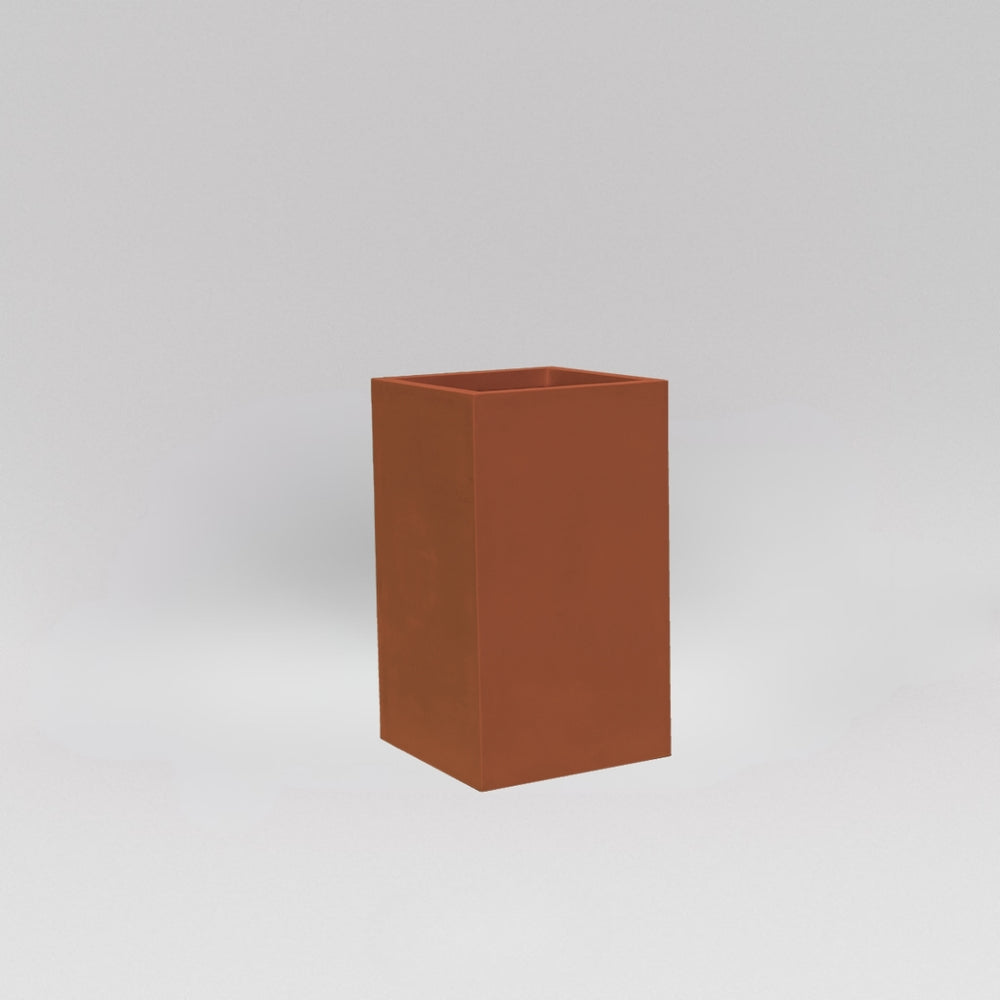 Darwin Tall Corner Fiberglass Planter in matte terra cotta against gray background.