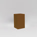 Darwin Tall Corner Fiberglass Planter in metallic bronze against gray background.