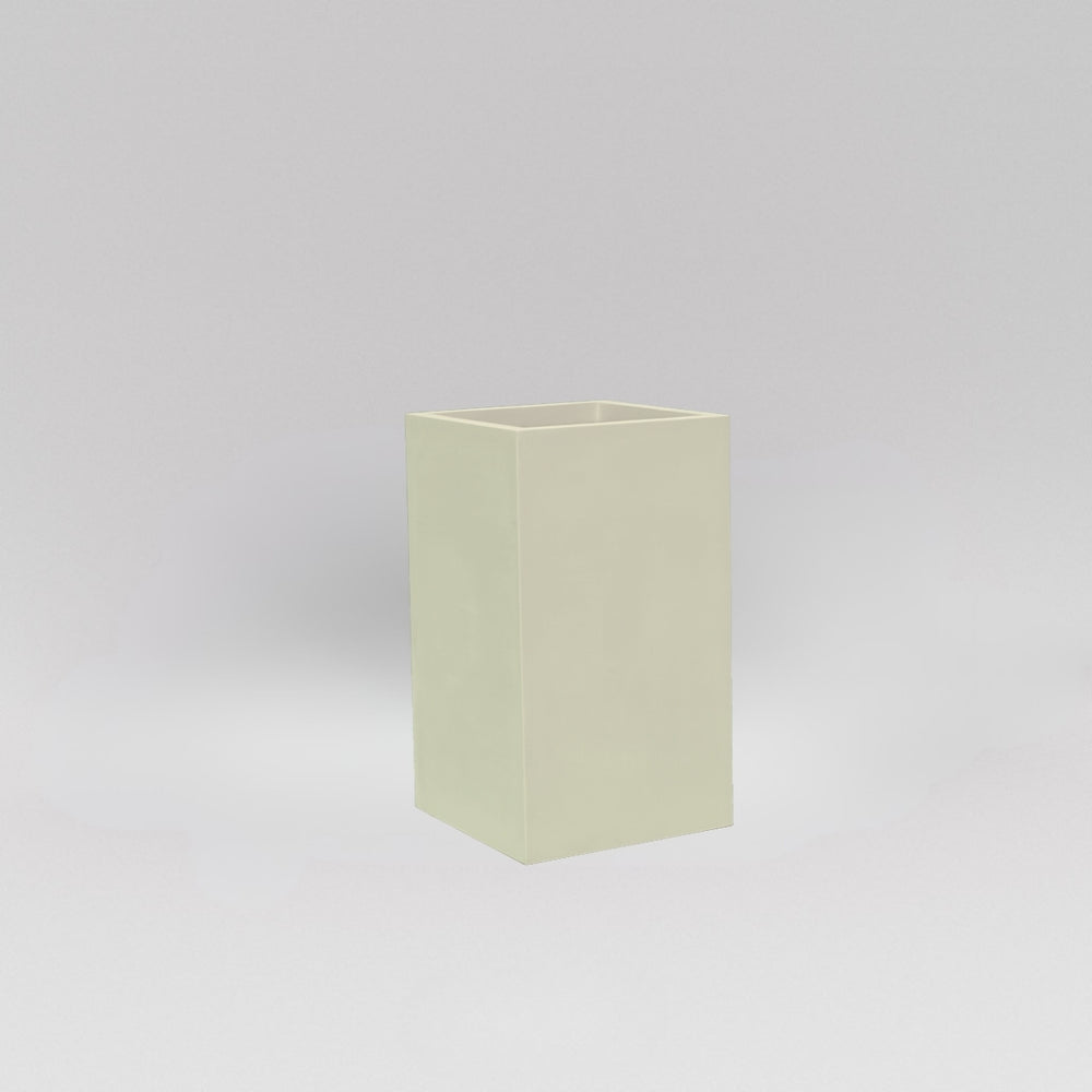 Darwin Tall Corner Fiberglass Planter in satin beige against gray background.