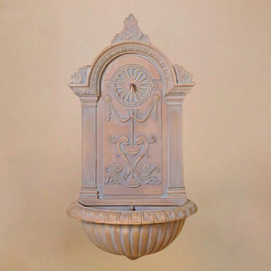 Delfino Wall Fountain against brown background.