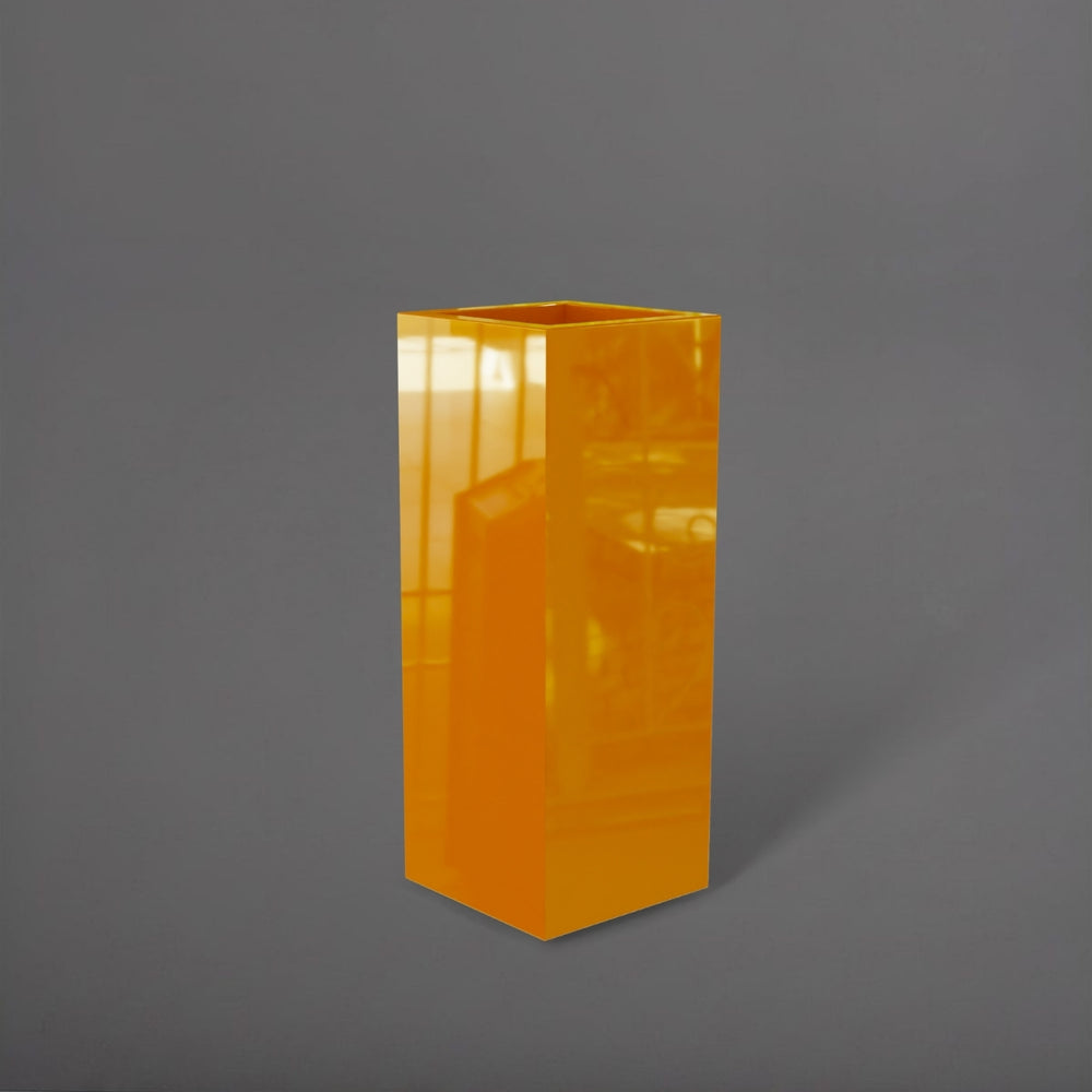 Delray Tall Corner Fiberglass Planter in gloss tangerine against gray background.