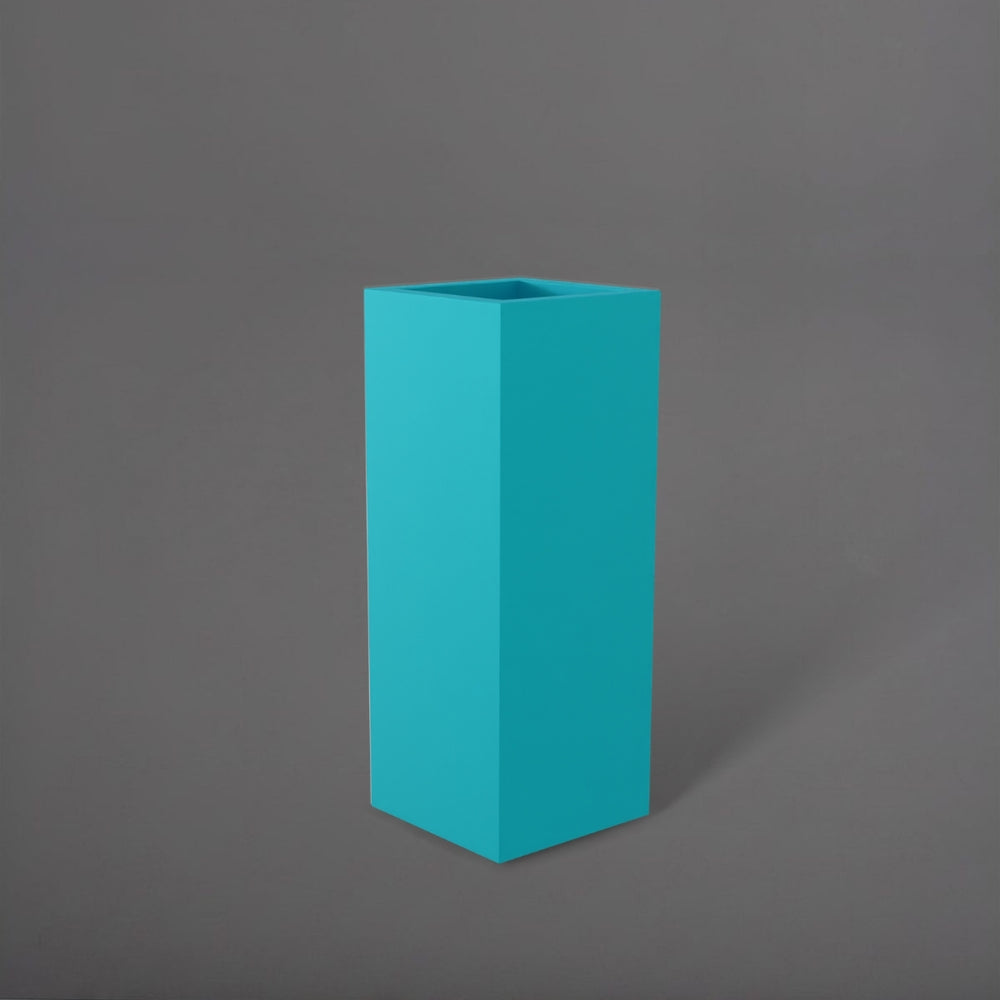 Delray Tall Corner Fiberglass Planter in satin seafoam green against gray background.