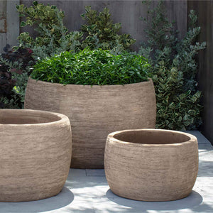 Denali Planter, Low - Brown Terra Cotta - S/3 on concrete filled with plants