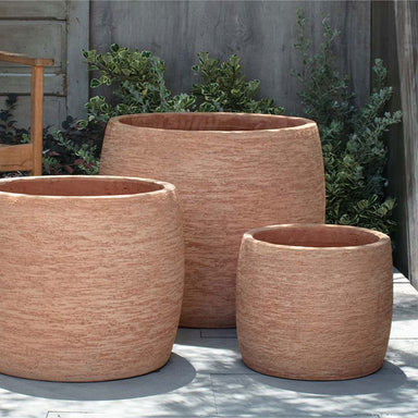 Denali Planter - Terra Cotta - S/3 on concrete against green plants