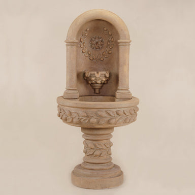 Deruta Lemon Niche Fountain against brown background.