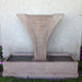 Diesse Fountain with side spillways in action against cream wall.