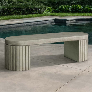 Dorchester Fluted Bench on concrete near a swimming pool.
