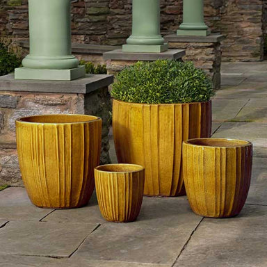 Dunes Planter - Honey - S/4 on concrete filled with plants