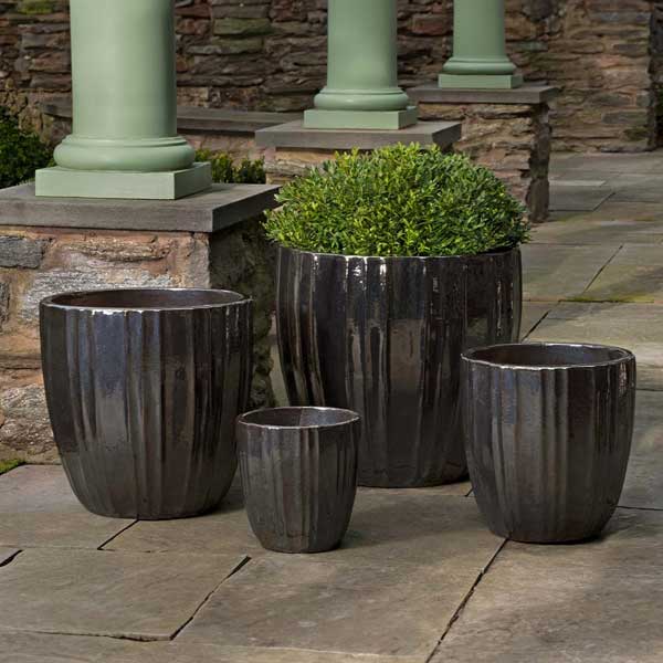 Dunes Planter - Metallic - S/4 on concrete filled with plants