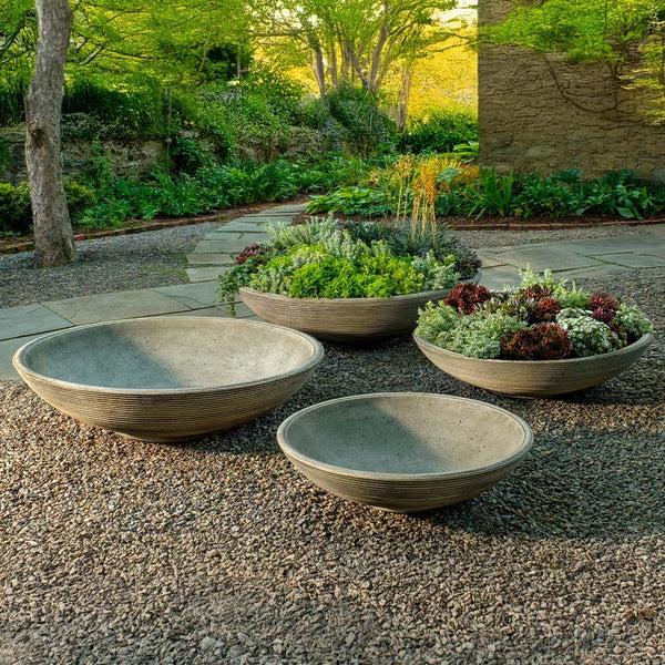 Enso Bowl with four different sizes on gravel in the backyard.