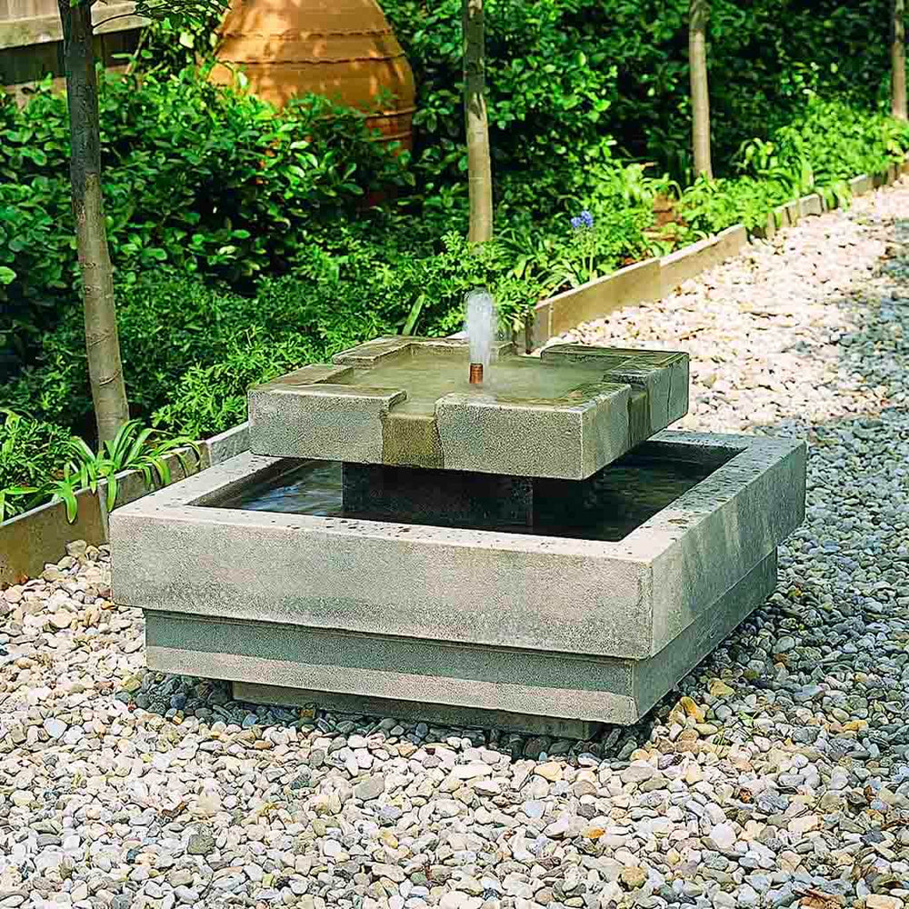 Escala Garden Bubbler Fountain in action on stone rocks