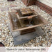 Facet Fountain on concrete surrounded with white pebbles in action.
