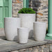 Falling Petals Planter, Tall - Pearl - S/4 filled with plants on patio.