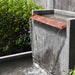 Falling Water 2 Fountain on gravel in action upclose sideview.