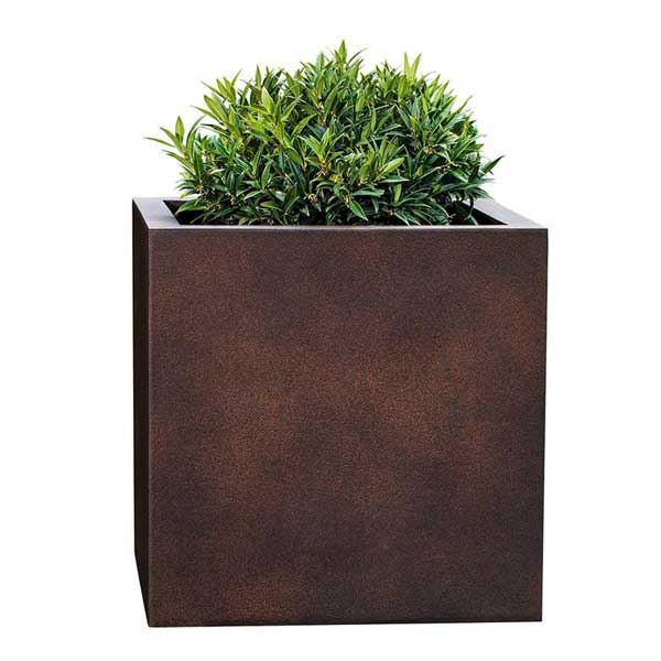 Farnley Planter 1818 S/1 in rust lite filled with plants against white background.