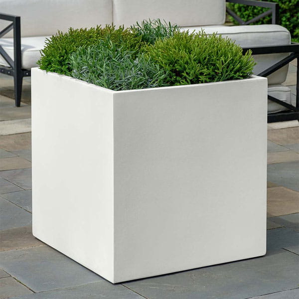 Farnley Planter 2828 S/1 in chalk lite on concrete filled with plants.