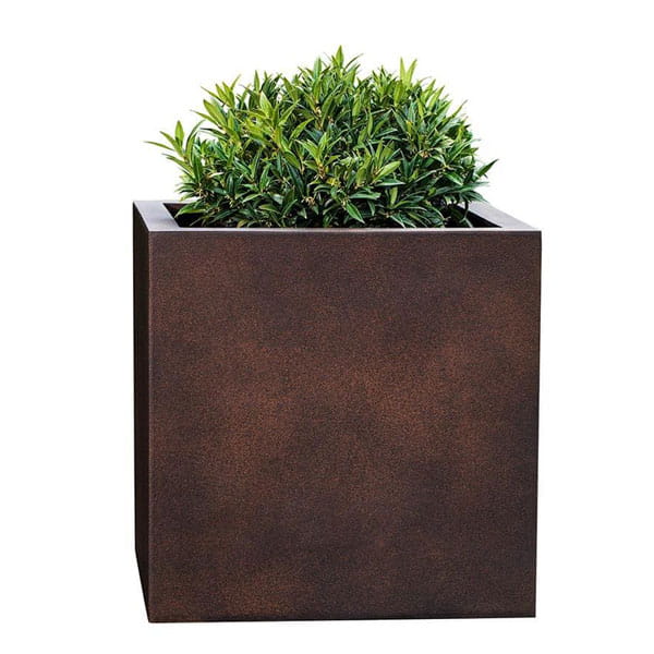 Farnley Planter 2828 S/1 in rust lite filled with plants against white background.