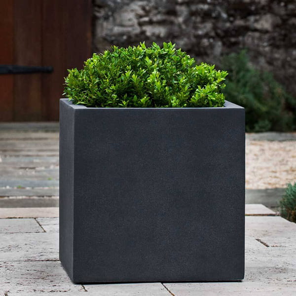 Farnley Planter 3636 S/1 in lead lite on concrete filled with plants.