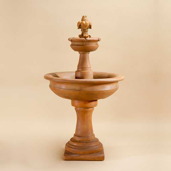 Fleur de Lis Two Tier Fountain against brown background.