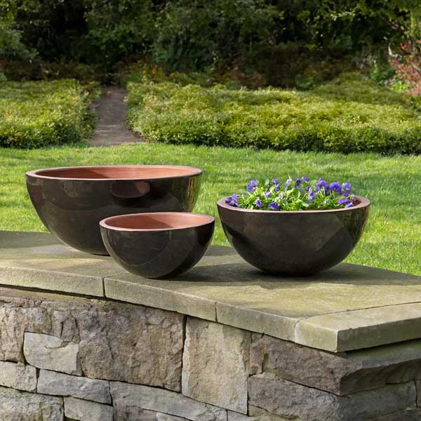 Glenside Bowl Planter - Cola - S/3 filled with purple flowers in the backyard