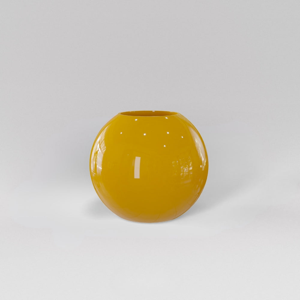 Globe Fiberglass Planter in gloss saffron against gray background.