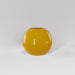 Globe Fiberglass Planter in gloss saffron against gray background.