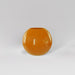 Globe Fiberglass Planter in gloss tangerine against gray background.