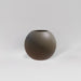 Globe Fiberglass Planter in matte bronze against gray background.