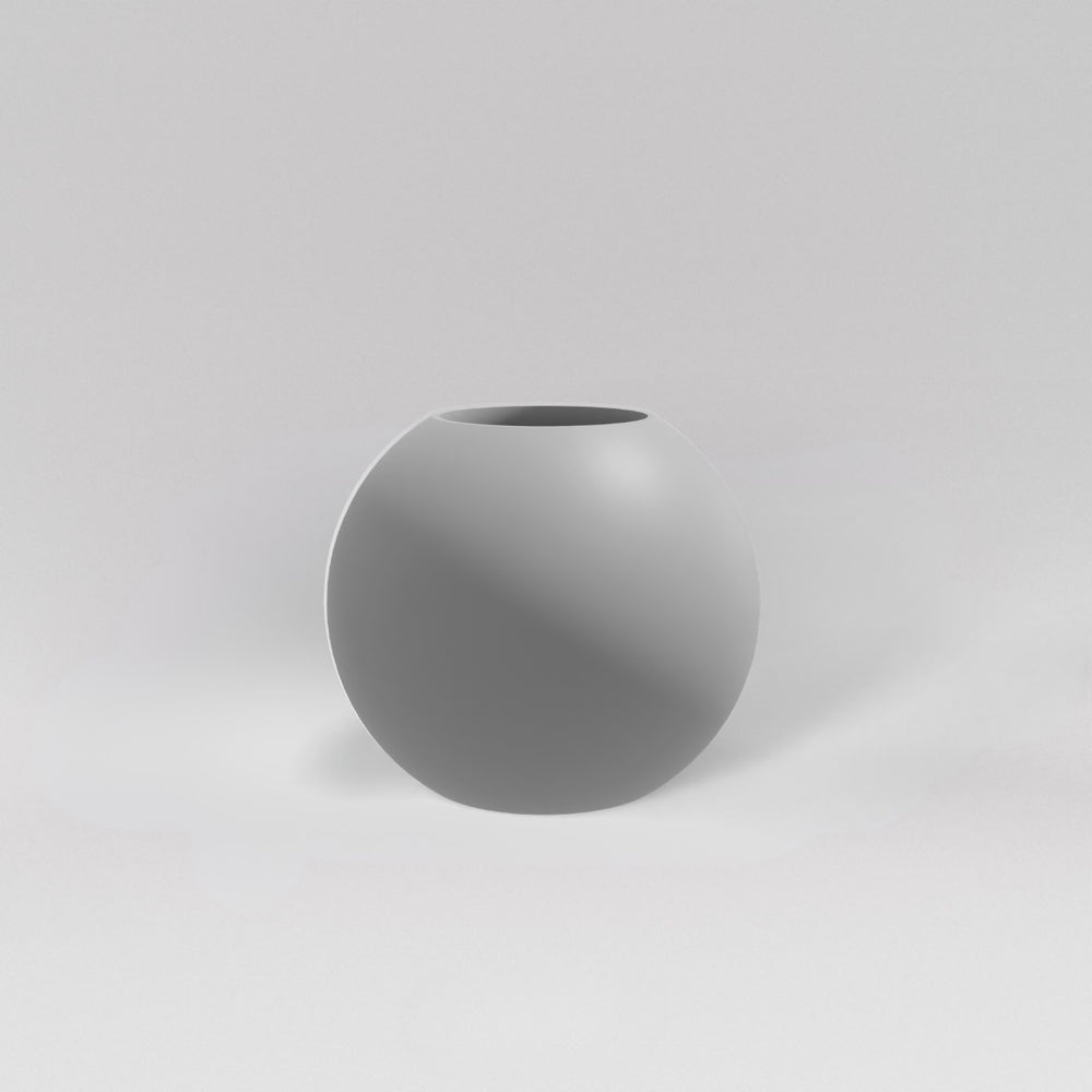 Globe Fiberglass Planter in matte cement grey against gray background.