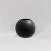 Globe Fiberglass Planter in matte charcoal against gray background.