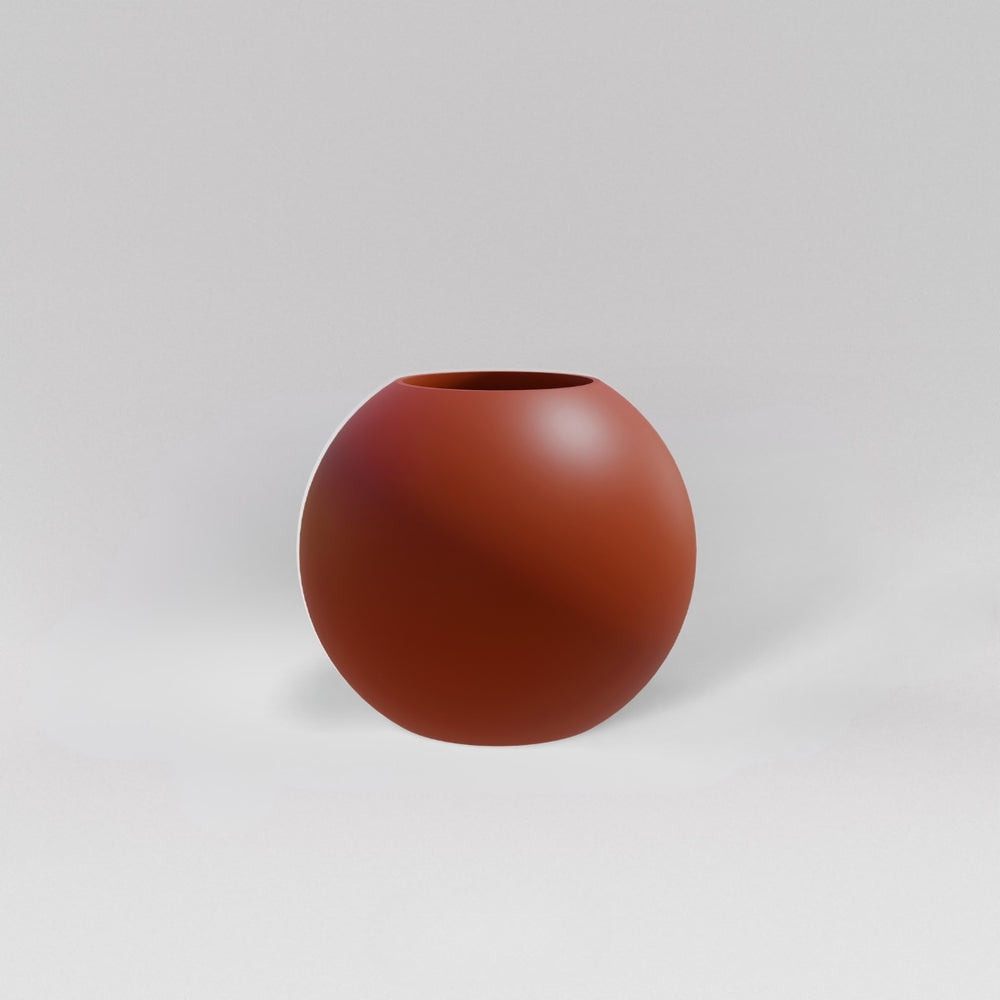 Globe Fiberglass Planter in matte terra cotta against gray background.