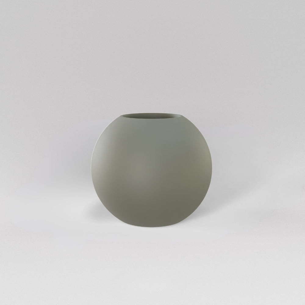 Globe Fiberglass Planter in satin beige against gray background.