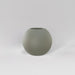 Globe Fiberglass Planter in satin beige against gray background.