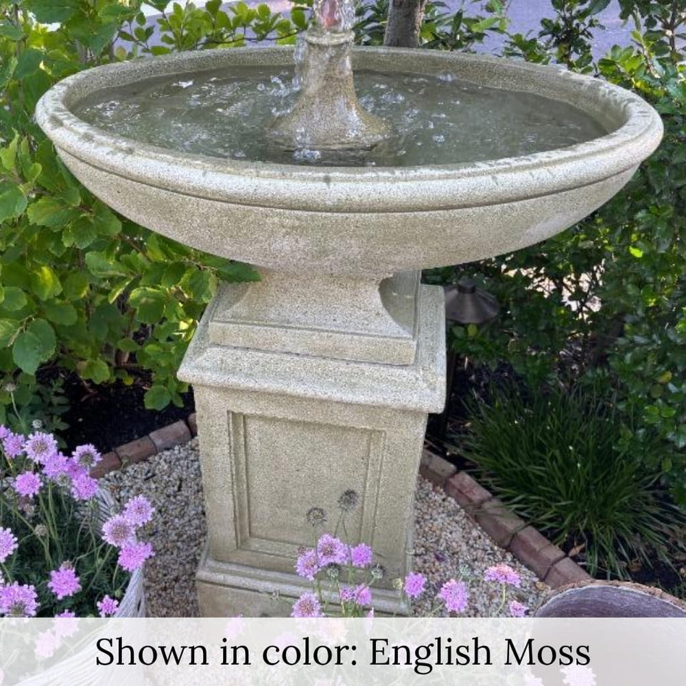 Gramercy Fountain in action beside purple flowers.