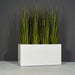 Granada Wide Rectangle Fiberglass Planter on concrete filled with plants.
