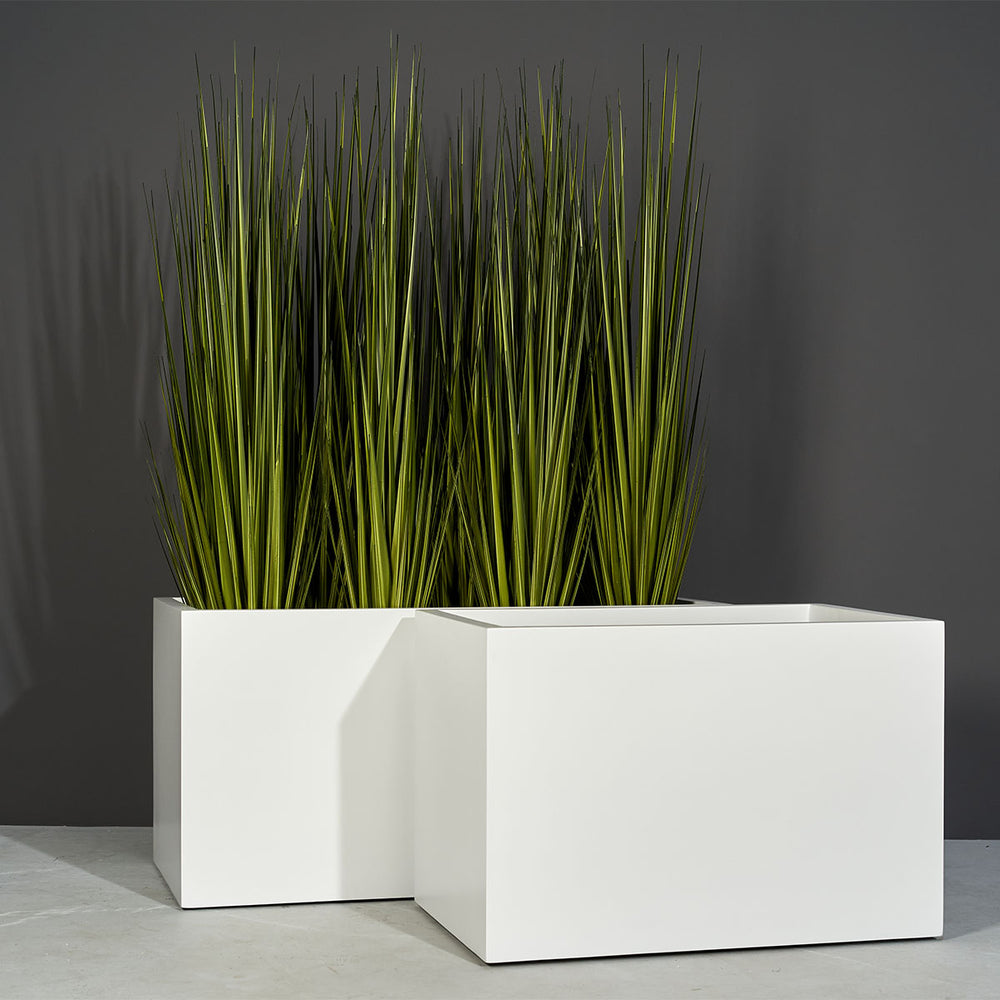 Granada Wide Rectangle Fiberglass Planter shown with different sizes filled with plants.