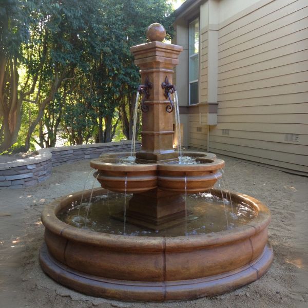 Grand Avignon Courtyard Fountain in the backyard in a pond.