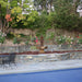Grand Avignon Courtyard Fountain in the garden near a swimming pool.