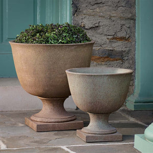 Hampstead Urn, Extra Large and Large on concrete filled with plants