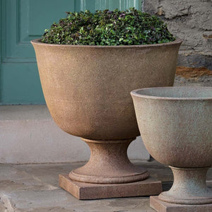 Hampstead Urn, Extra Large on concrete filled with plants
