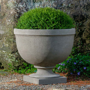 Huntington Urn, Extra Small on gravel filled with plants
