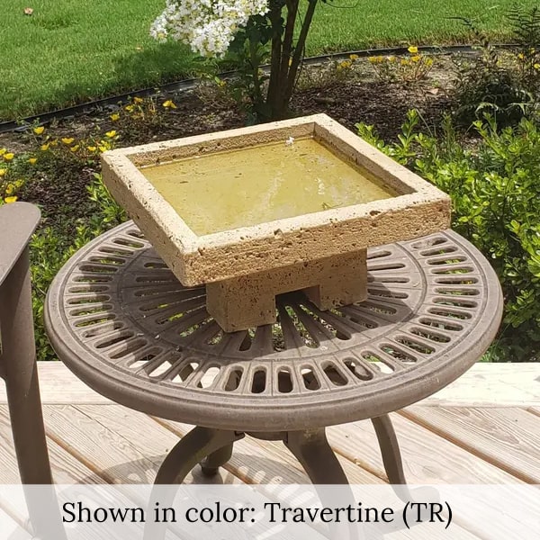 Kosei Birdbath on table against white flowers upclose