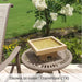 Kosei Birdbath on table against white flowers