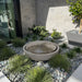 Large Girona Bubbling water fountain in action in rock garden