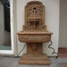 Lemon Lavabo Wall Fountain on concrete in action.