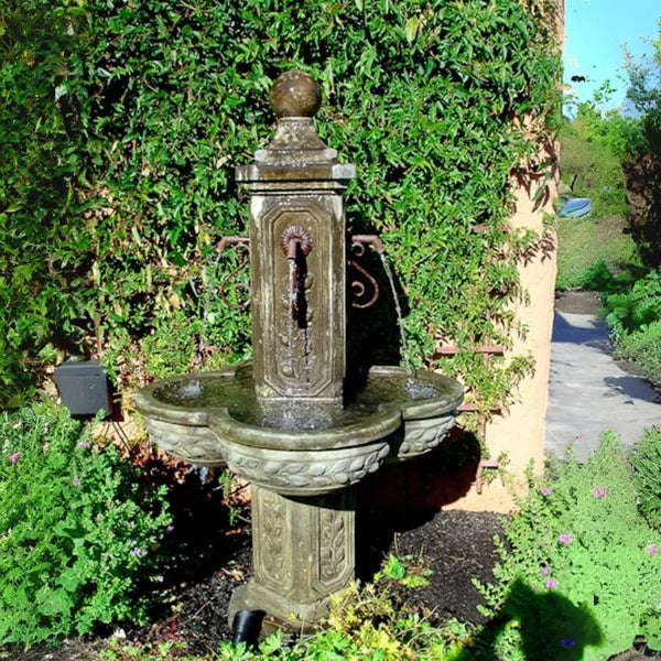 Limone Courtyard Fountain in the backyard against green plants.