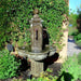 Limone Courtyard Fountain in the backyard against green plants.