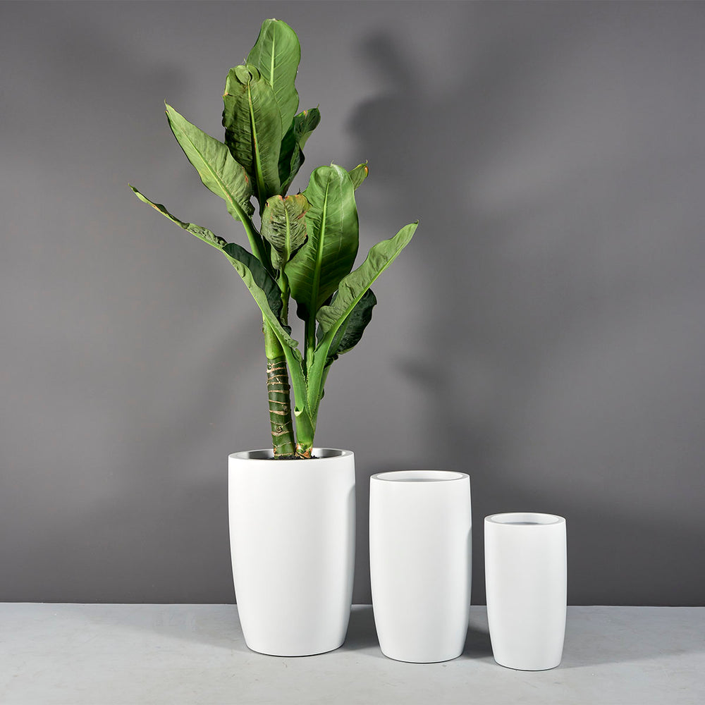 Lisbon Tall Round Tapered Fiberglass Planter shown with different sizes filled with plants.