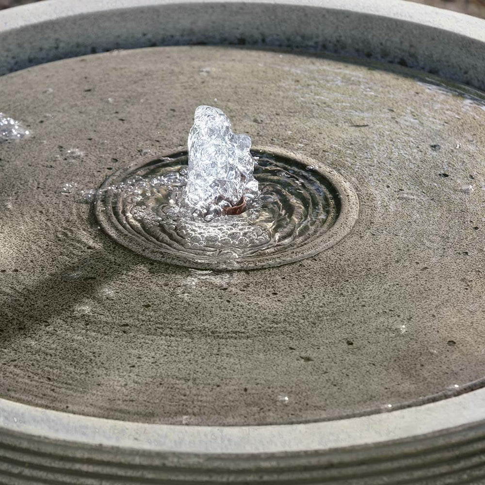 Longitude Fountain on gravel in the backyard upclose.