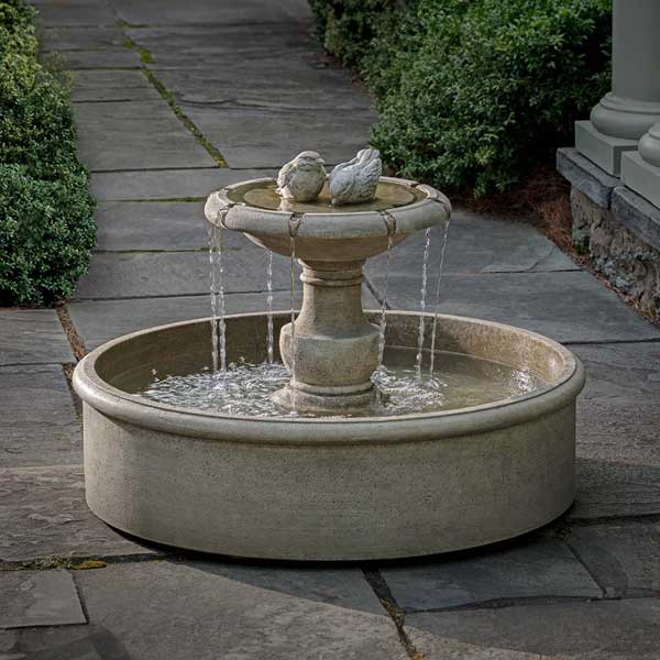 Lucienne Fountain on concrete with plants background